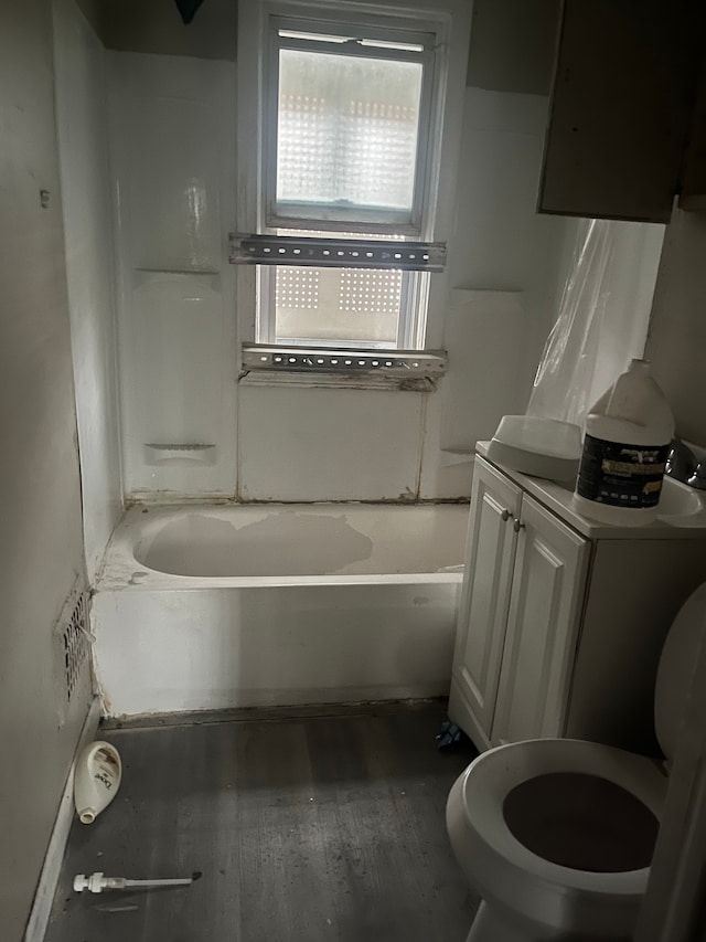 full bathroom with vanity, toilet, wood-type flooring, and tub / shower combination