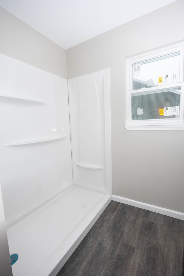 bathroom featuring wood-type flooring and walk in shower