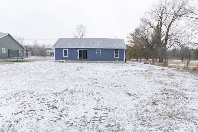 snow covered property featuring a trampoline