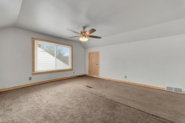 interior space with carpet flooring, ceiling fan, and vaulted ceiling