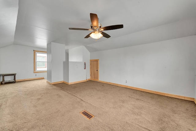 additional living space with ceiling fan, lofted ceiling, and carpet floors