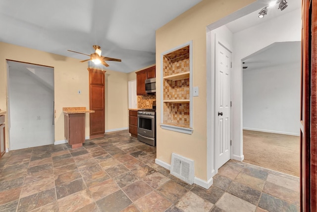 kitchen with tasteful backsplash, ceiling fan, dark colored carpet, and appliances with stainless steel finishes