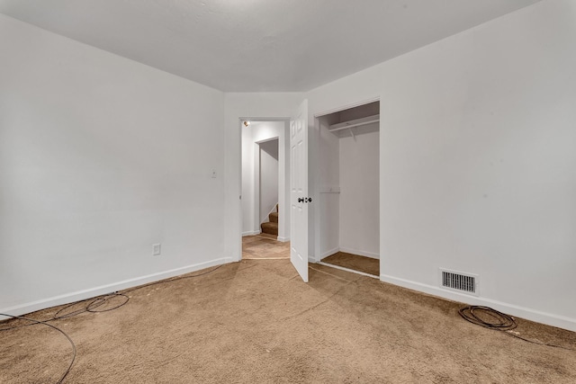 unfurnished bedroom with a closet and carpet floors