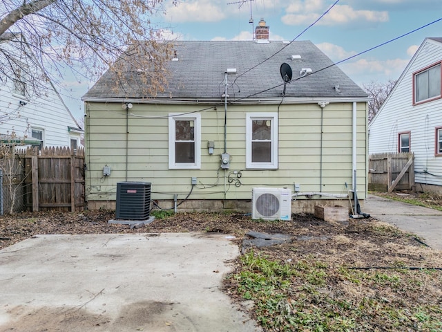 back of house with a patio area, ac unit, and cooling unit