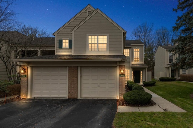 view of front of home featuring a front yard and a garage