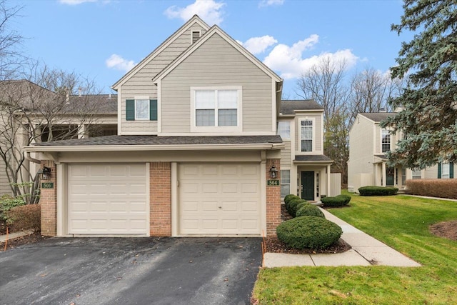 view of front of property with a garage and a front lawn