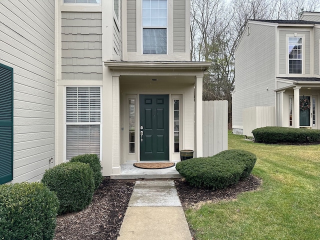 property entrance featuring a lawn