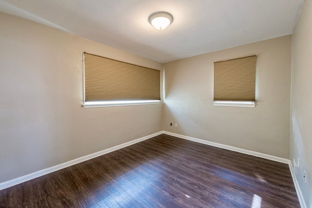 spare room featuring dark hardwood / wood-style floors