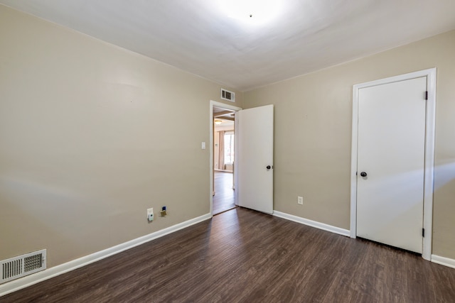 unfurnished bedroom with dark wood-type flooring