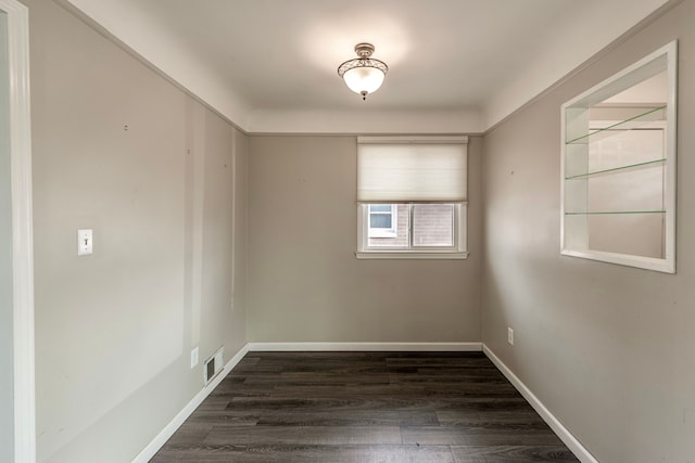 unfurnished room with dark hardwood / wood-style floors