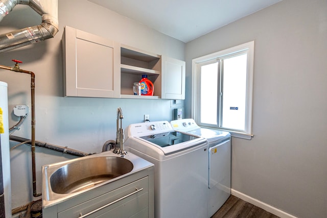 washroom featuring cabinets, separate washer and dryer, sink, and dark hardwood / wood-style flooring