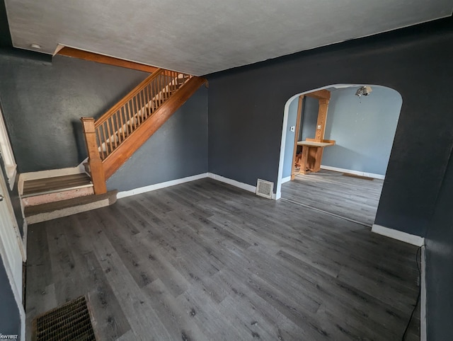 unfurnished living room featuring dark hardwood / wood-style flooring