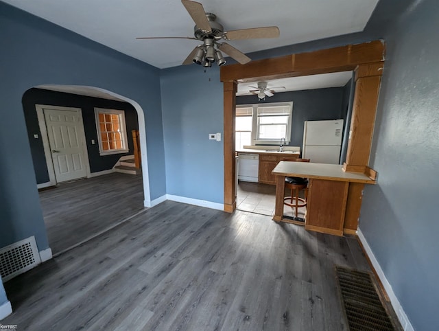 interior space with ceiling fan, hardwood / wood-style floors, and sink