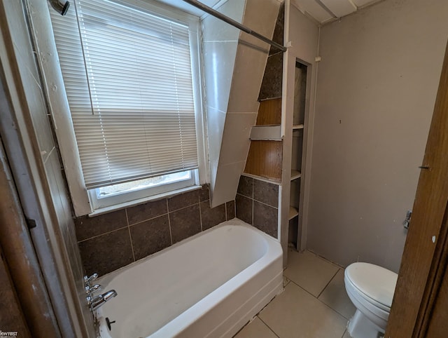 bathroom with toilet and tile patterned flooring