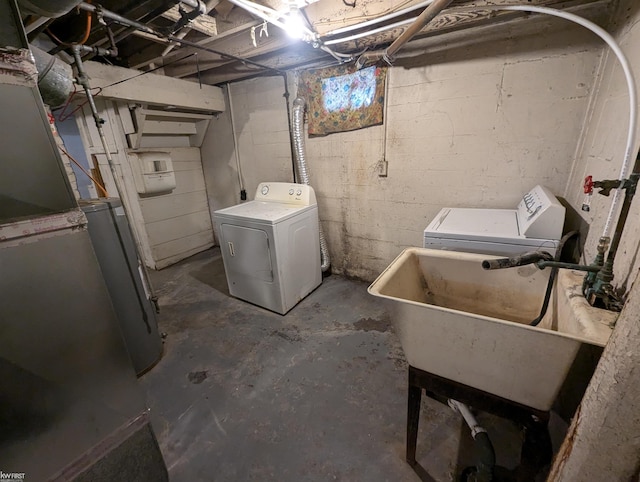 laundry room featuring washer and dryer, sink, and gas water heater