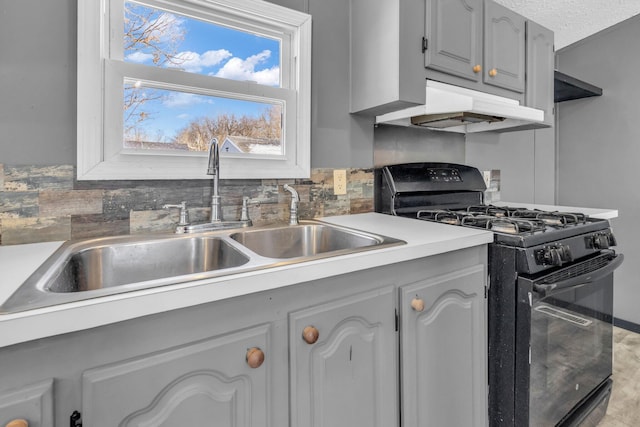 kitchen with backsplash, gray cabinets, sink, and black range with gas cooktop