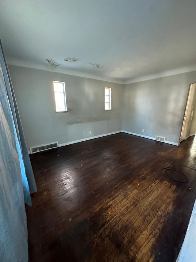 empty room with dark wood-type flooring