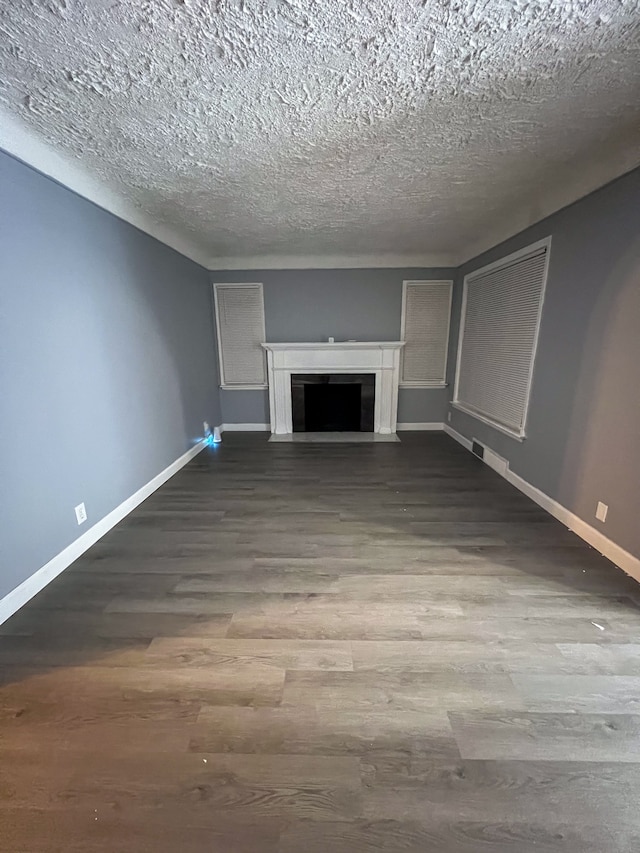 unfurnished living room with hardwood / wood-style floors and a textured ceiling