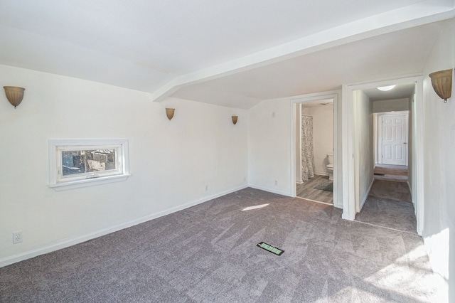 unfurnished bedroom featuring light carpet and connected bathroom