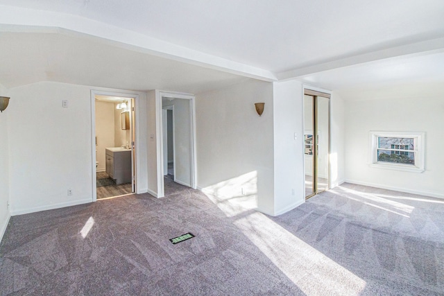 unfurnished room with carpet and lofted ceiling