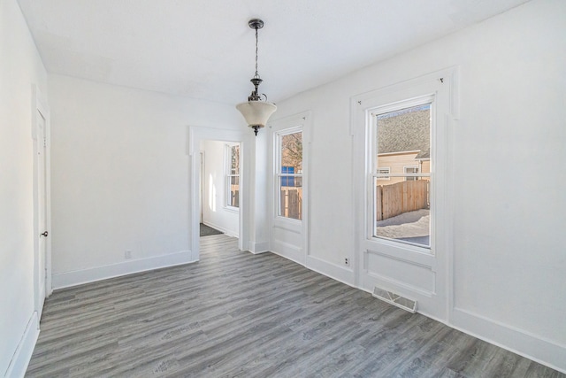 empty room with dark hardwood / wood-style flooring