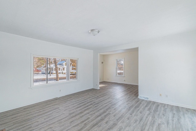 unfurnished room with light wood-type flooring