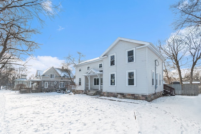 view of snow covered rear of property