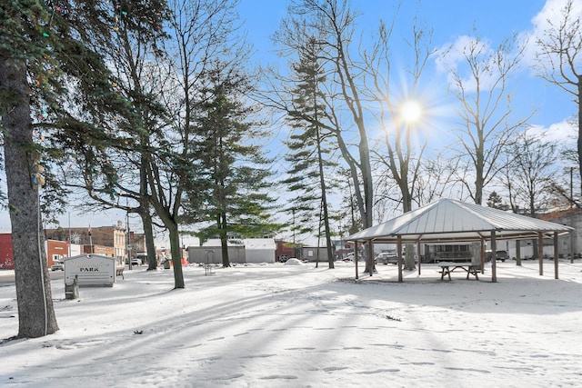 snowy yard featuring a gazebo