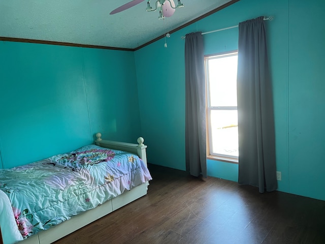 bedroom featuring ceiling fan, ornamental molding, and multiple windows