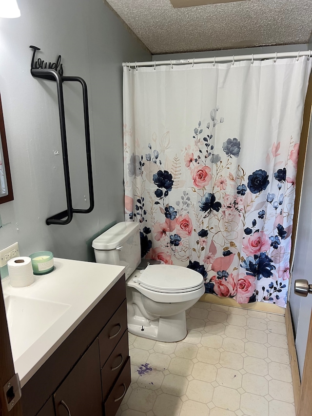 bathroom with vanity, a shower with shower curtain, tile patterned flooring, toilet, and a textured ceiling