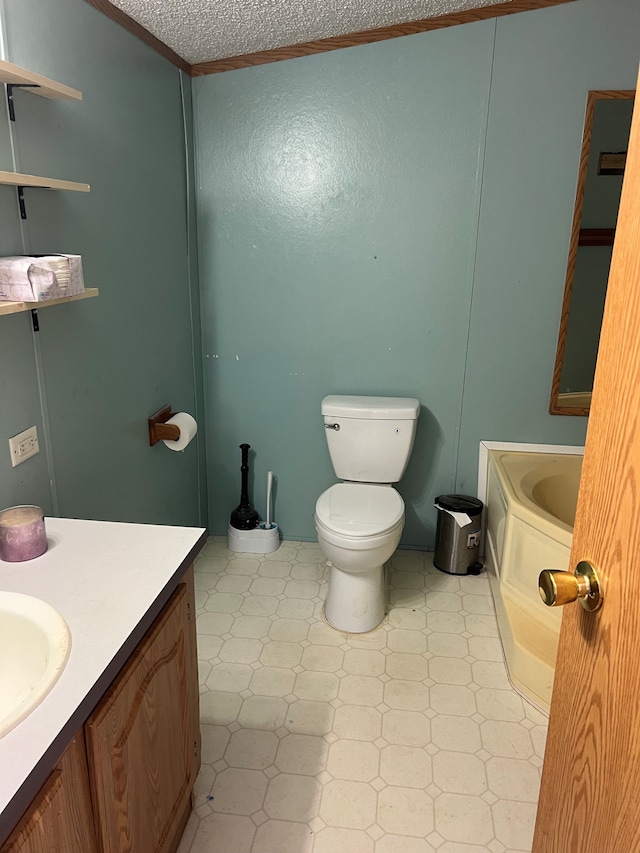 bathroom featuring vanity, toilet, a textured ceiling, and crown molding