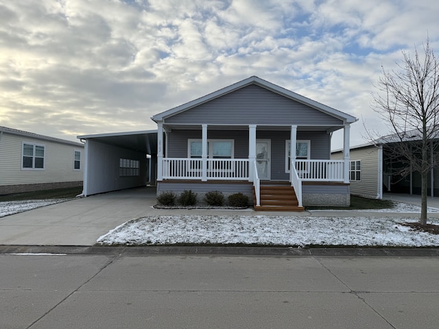 view of front facade with covered porch and a carport