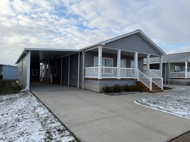 view of front of home featuring a porch and a carport