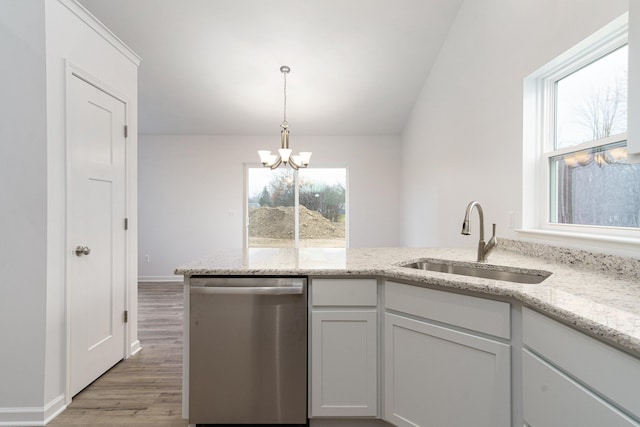 kitchen with sink, white cabinetry, an inviting chandelier, light stone counters, and stainless steel dishwasher