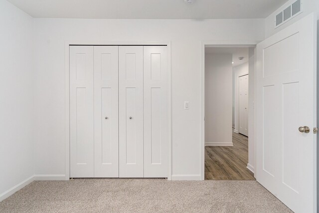 unfurnished bedroom featuring a closet and carpet