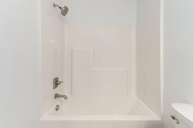 bathroom featuring toilet and bathing tub / shower combination