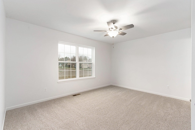 spare room with carpet and ceiling fan