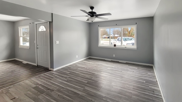 entryway with dark hardwood / wood-style flooring and ceiling fan