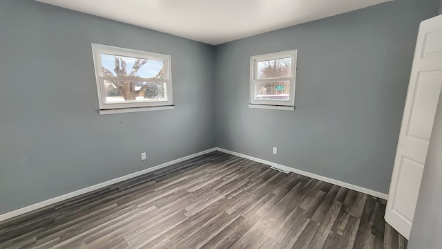 unfurnished room with dark hardwood / wood-style floors