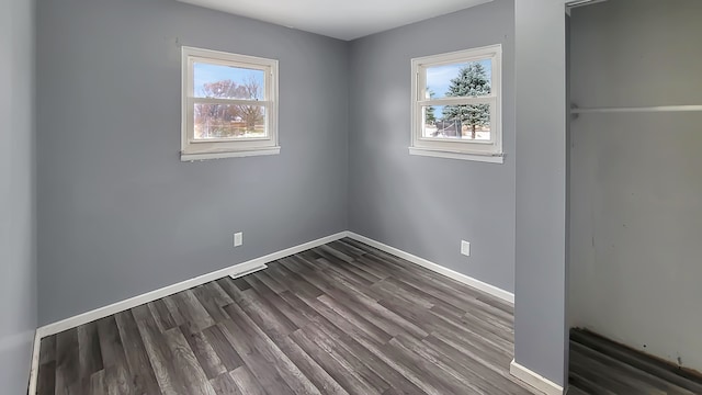 spare room with hardwood / wood-style floors and a wealth of natural light