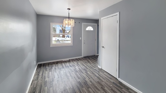 entryway featuring dark hardwood / wood-style flooring and a chandelier