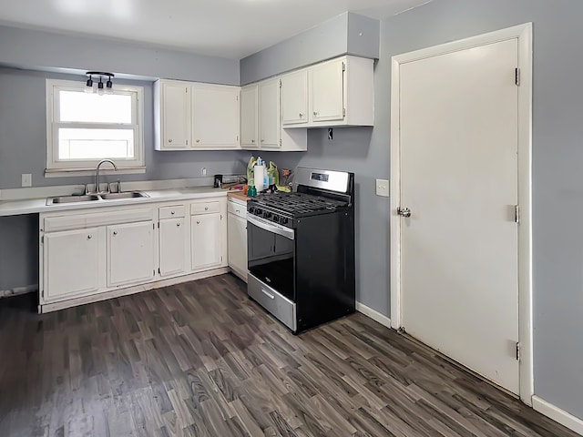 kitchen with white cabinets, gas range, dark wood-type flooring, and sink