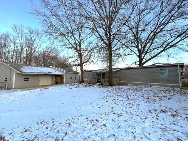 view of snow covered rear of property