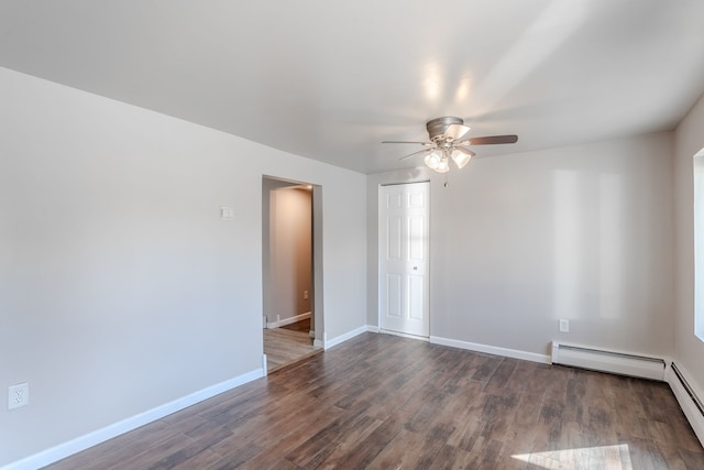 empty room with dark hardwood / wood-style floors, ceiling fan, and a baseboard heating unit