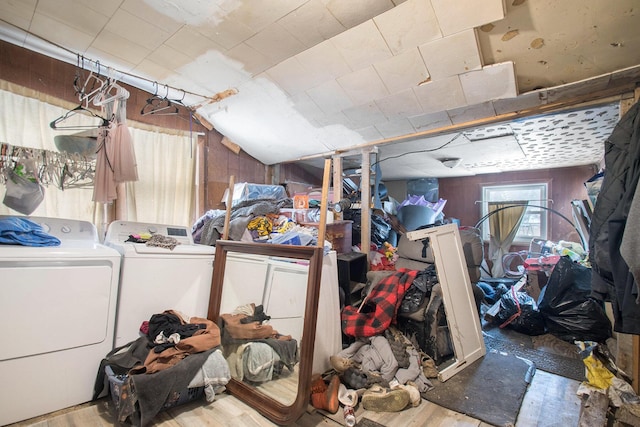 basement featuring wood walls, light hardwood / wood-style flooring, and independent washer and dryer