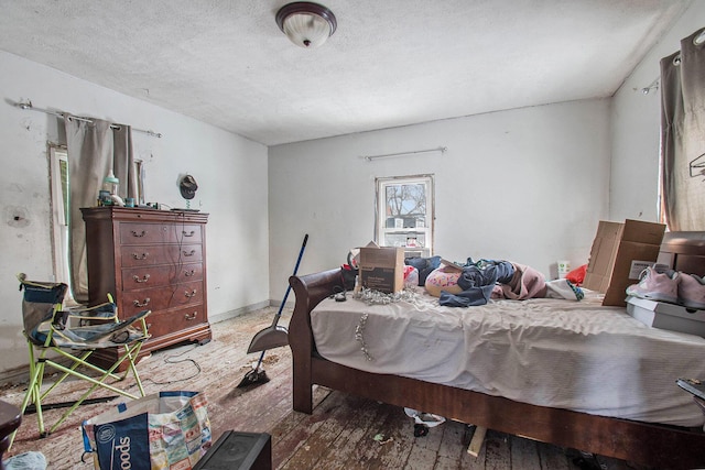 bedroom with wood-type flooring and a textured ceiling