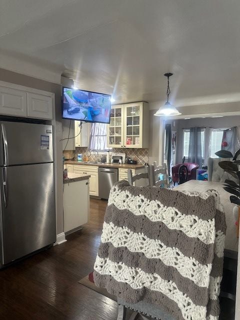 1220 Elford Ct, Grosse Pointe Woods, MI 48236 - kitchen featuring stainless steel appliances, decorative backsplash, dark wood finished floors, glass insert cabinets, and open floor plan