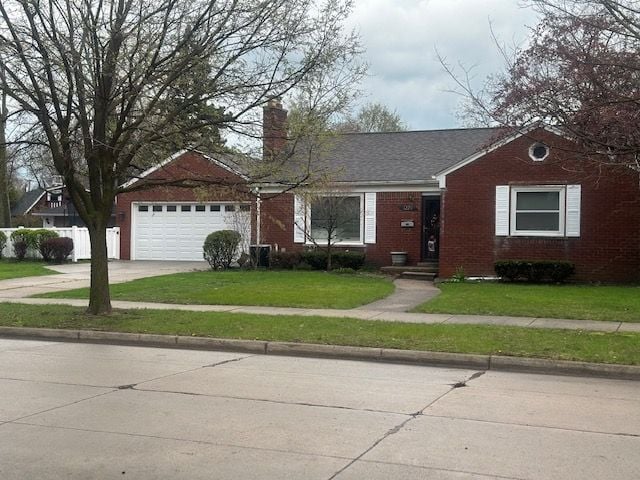 ranch-style home with a front yard and a garage