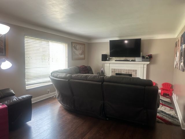 1220 Elford Ct, Grosse Pointe Woods, MI 48236 - living area with dark wood-style floors and a tiled fireplace