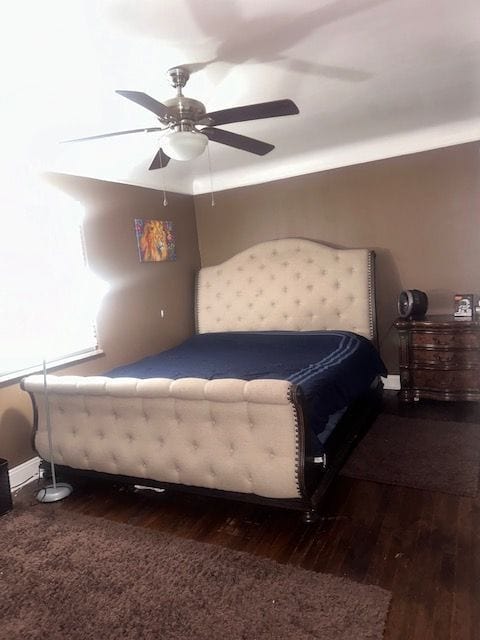 bedroom with ceiling fan and dark wood-type flooring